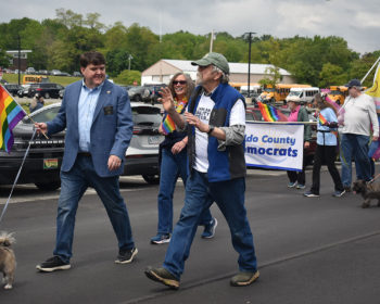 Sen. Chip Curry, Rep. Jan Dodge, Rep. Paige Zeigler in the 2023 Belfast Has Pride Parade, in front of the Waldo County Democrats banner.