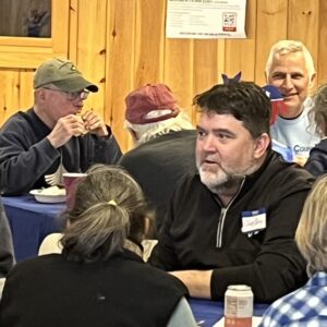 Senator Chip Curry and other local Democrats enjoy the potluck lunch