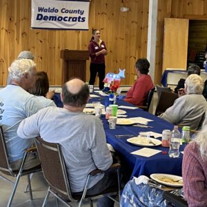 Elise Brown speaks to WCDC members at the spring potluck