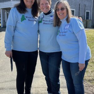 Midge, Sara and Cheryl pose in their blue Waldo County Democrats t-shirts in front of the Searsmont Town Office after the spring potluck