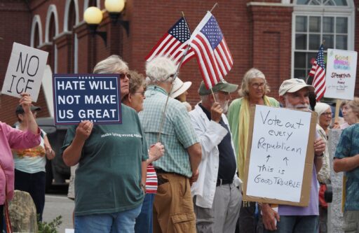 Protesters in Belfast with signs reading, "Vote out every Republican - this is good trouble" and "Hate will not make US great"