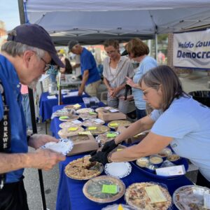 WCDC member serving a piece of pie at our sale at the Belfast Street Party