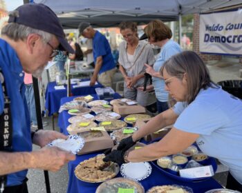 WCDC member serving a piece of pie at our sale at the Belfast Street Party