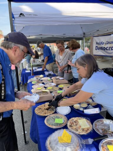 WCDC member serving a piece of pie at our sale at the Belfast Street Party