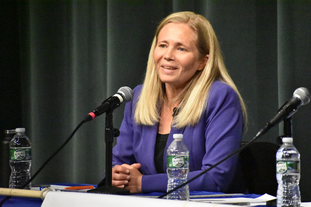 Candidate Hannah Pingree in a purple blazer at the microphone.