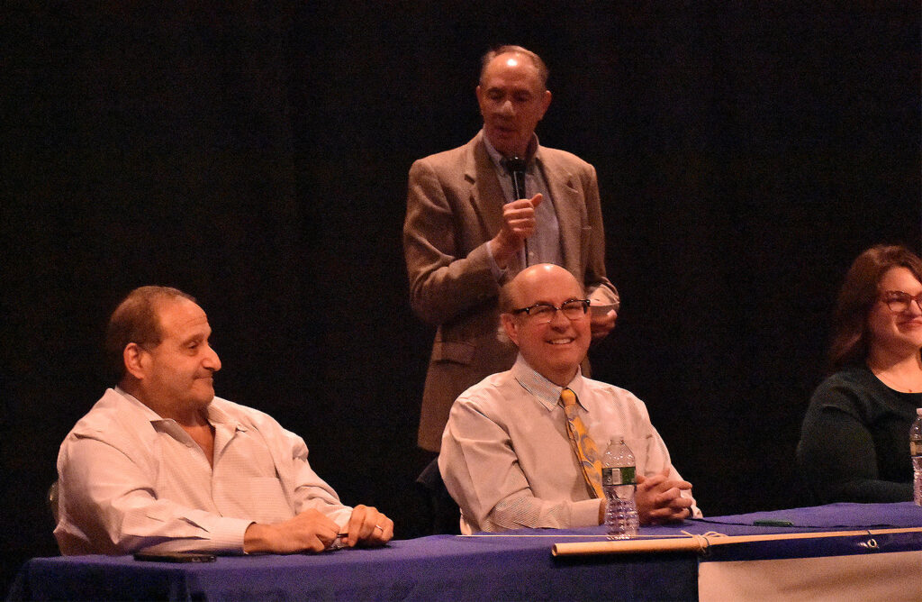 Candidates Joe Baldacci and Matt Dunlap smile at a comment by moderator Tom Groening. Candidate Paige Loud is partially pictured.