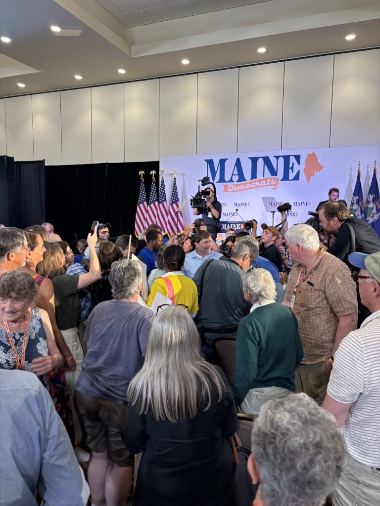 Scene at the convention as delegates crowd around nominee Troy Jackson on the convention floor